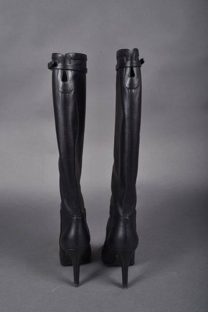 CHANEL
Pair of black leather boots, strap...