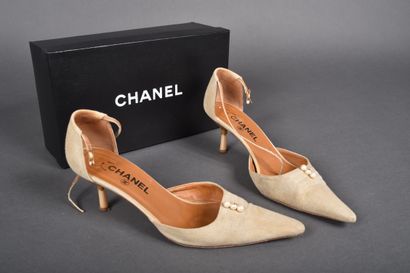 CHANEL
Pair of beige canvas pointed-toe pumps,...