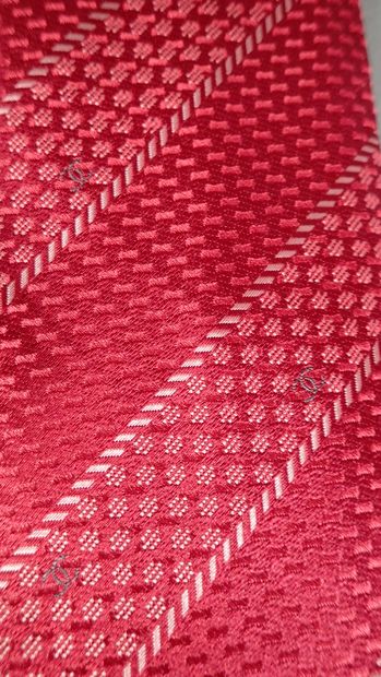 CHANEL. Silk tie with red background decorated...
