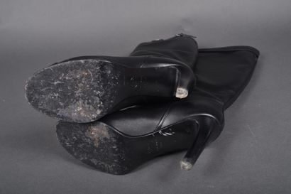 CHANEL
Pair of black leather boots, strap...