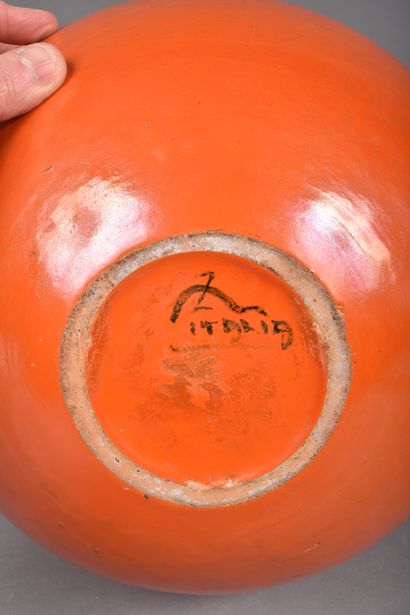 Large globular ceramic vase with orange glaze....