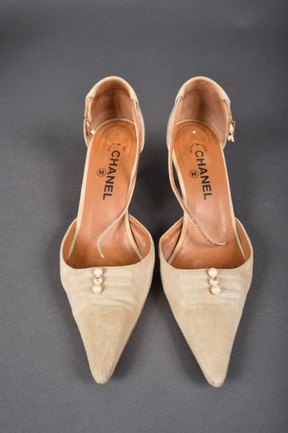 CHANEL
Pair of beige canvas pointed-toe pumps,...