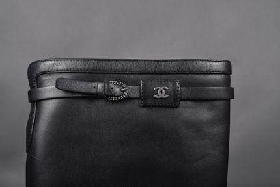 CHANEL
Pair of black leather boots, strap...