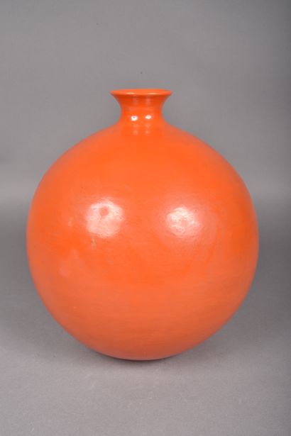 Large globular ceramic vase with orange glaze....