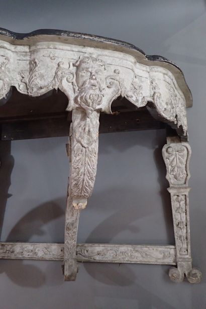 A large console table in carved wood with...