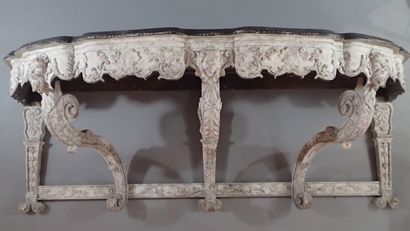 A large console table in carved wood with...