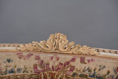 A large molded and carved beech sofa in cream,...