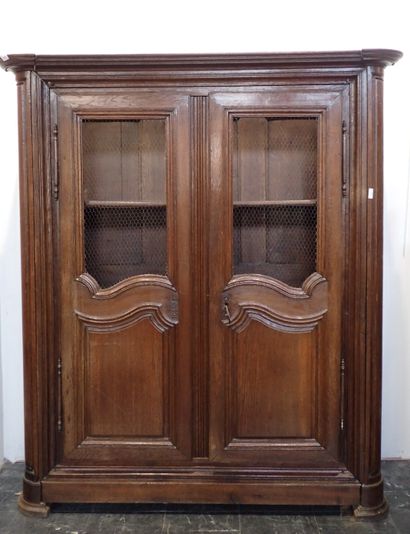 Moulded and carved oak bookcase opening on...