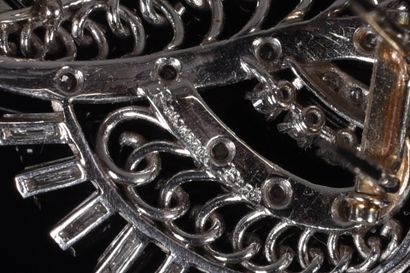 BOUCHERON. Leafy or scrolling brooch-clip...