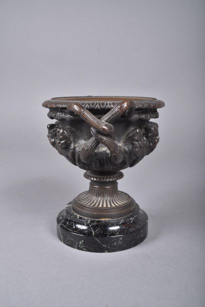 A bronze bowl with brown patina in the form...