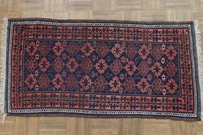 Oriental rug with geometric patterns in red...