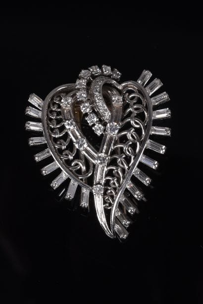 BOUCHERON. Leafy or scrolling brooch-clip...