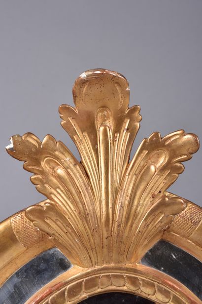 Gilded stuccoed wood mirror decorated with...