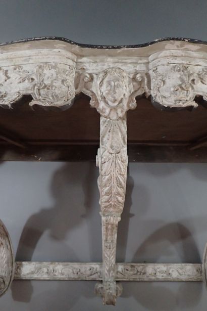 A large console table in carved wood with...