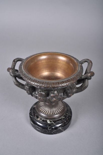 A bronze bowl with brown patina in the form...