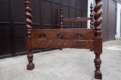 Moulded and carved rosewood bed resting on...