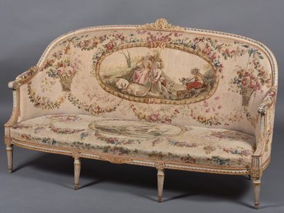 A large molded and carved beech sofa in cream,...