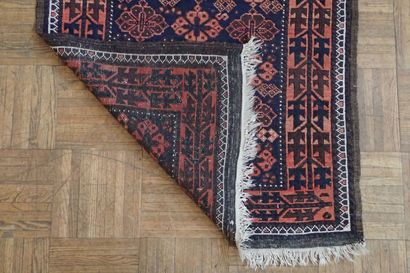 Oriental rug with geometric patterns in red...