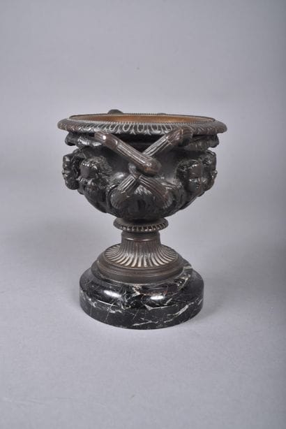 A bronze bowl with brown patina in the form...