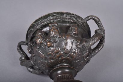 A bronze bowl with brown patina in the form...