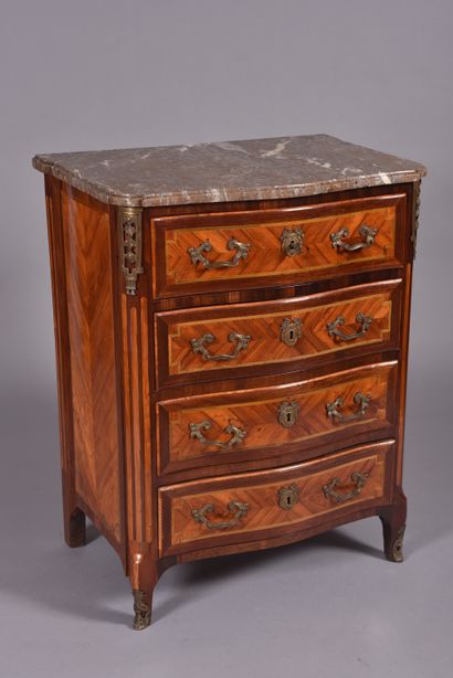 A lady's chest of drawers in veneered marquetry...