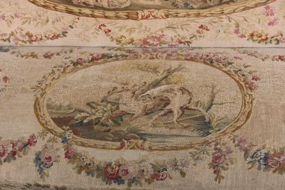 A large molded and carved beech sofa in cream,...