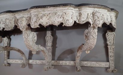 A large console table in carved wood with...