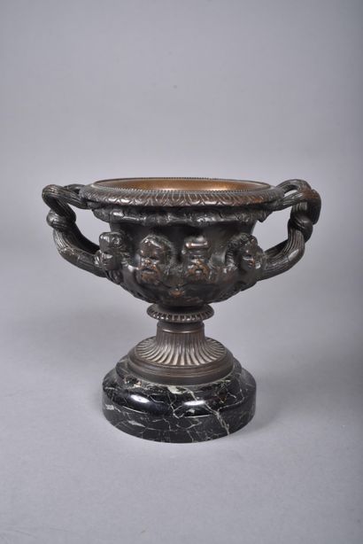 A bronze bowl with brown patina in the form...