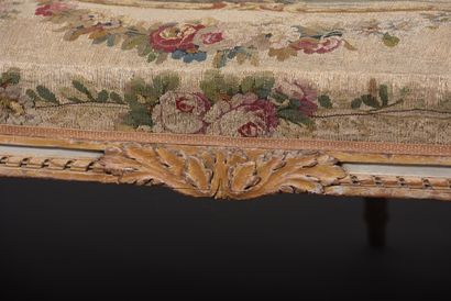 A large molded and carved beech sofa in cream,...