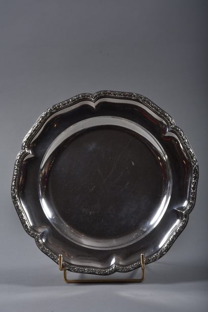 Circular serving dish with scalloped edges...