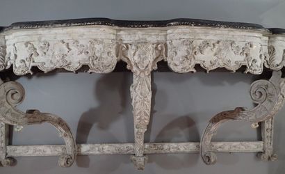 A large console table in carved wood with...