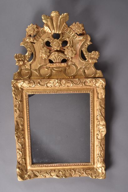 Gilded wood mirror decorated with lambrequins,...