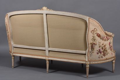 A large molded and carved beech sofa in cream,...