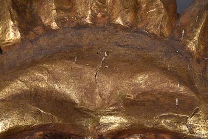 Large sun with smiling human face in gilded...