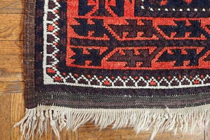 Oriental rug with geometric patterns in red...