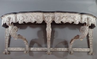A large console table in carved wood with...