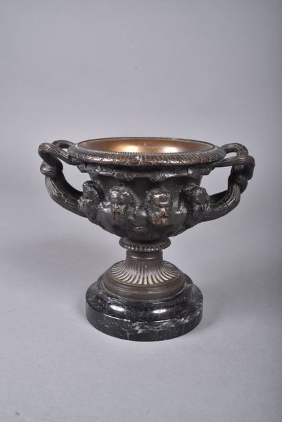 A bronze bowl with brown patina in the form...