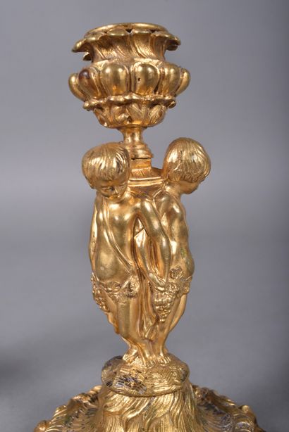 Pair of ormolu candlesticks, the tap in the...