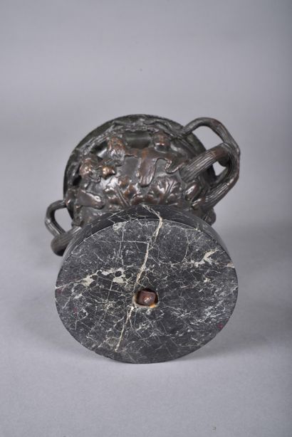 A bronze bowl with brown patina in the form...