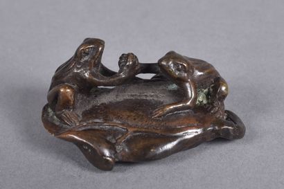 Small bronze paperweight with two frogs on...