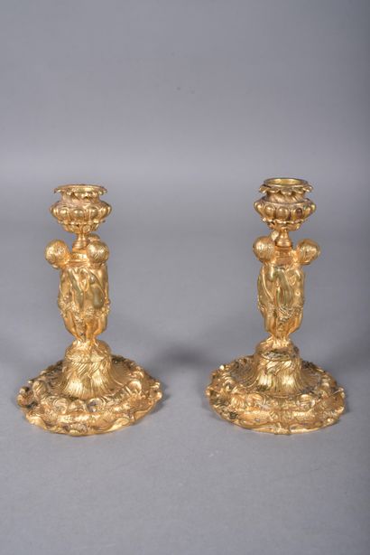 Pair of ormolu candlesticks, the tap in the...
