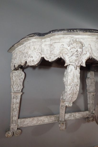 A large console table in carved wood with...