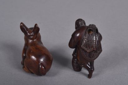 Set of two carved wooden netsukes, one depicting...