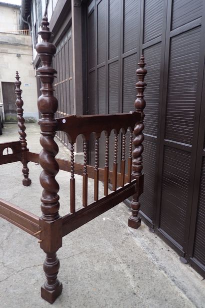 Moulded and carved rosewood bed resting on...