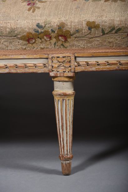 A large molded and carved beech sofa in cream,...