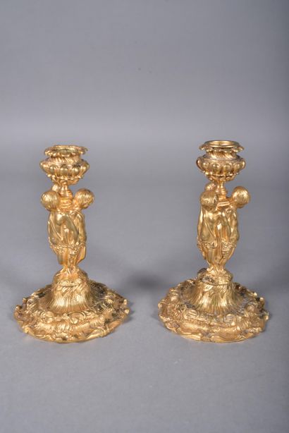 Pair of ormolu candlesticks, the tap in the...