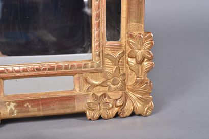 Gilded stuccoed wood mirror decorated with...