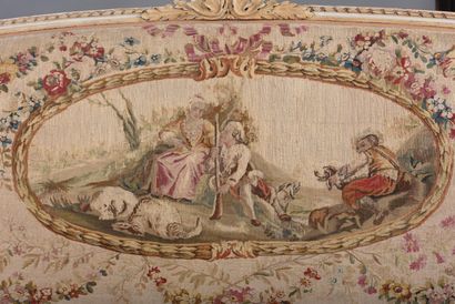 A large molded and carved beech sofa in cream,...