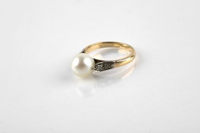 Yellow and white gold ring adorned with an...