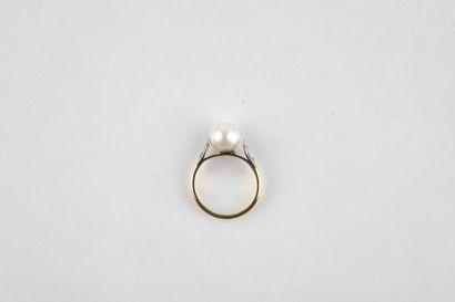 Yellow and white gold ring adorned with an...